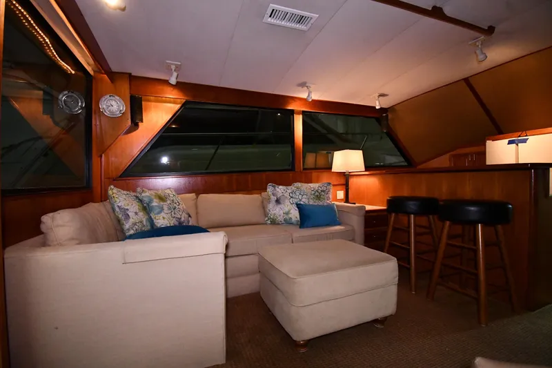 Slide: The Image of Interior of 1988 Viking 48 Convertible yacht with cozy seating and elegant decor. - 50