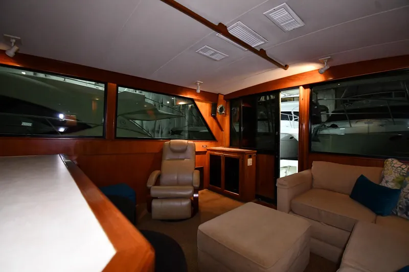 Slide: The Image of Interior of 1988 Viking 48 Convertible yacht with cozy seating and large windows. - 52