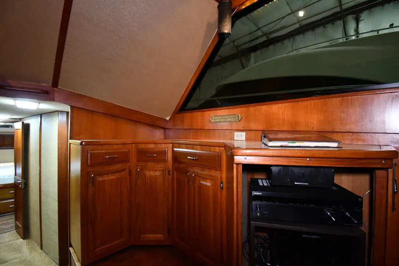 Slide: The Image of Interior of 1988 Viking 48 Convertible yacht with wooden cabinetry and entertainment system. - 53