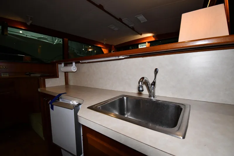Slide: The Image of Interior of 1988 Viking 48 Convertible yacht kitchen with sink and countertop. - 56