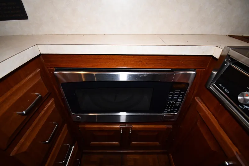 Slide: The Image of 1988 Viking 48 Convertible kitchen with built-in microwave and wooden cabinetry. - 58