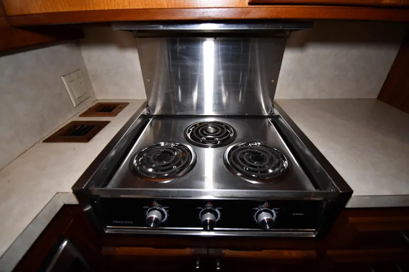 Slide: The Image of Electric stove in 1988 Viking 48 Convertible yacht kitchen, featuring three burners and stainless steel finish. - 59