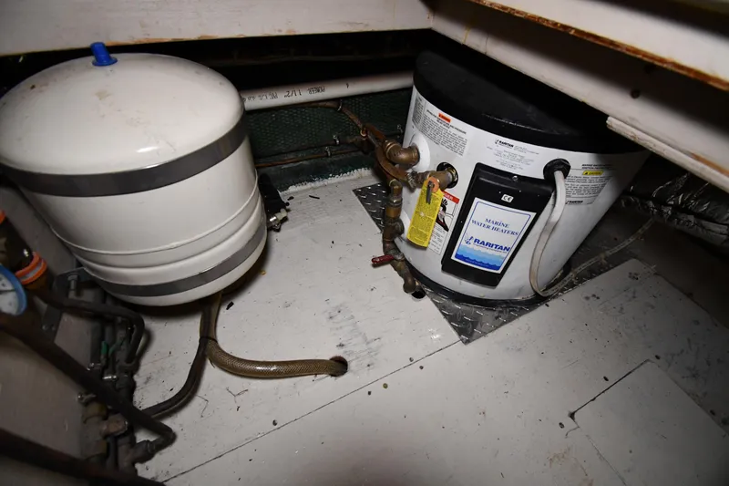 Slide: The Image of Engine room of 1988 Viking 48 Convertible with marine water heater and tank. - 61