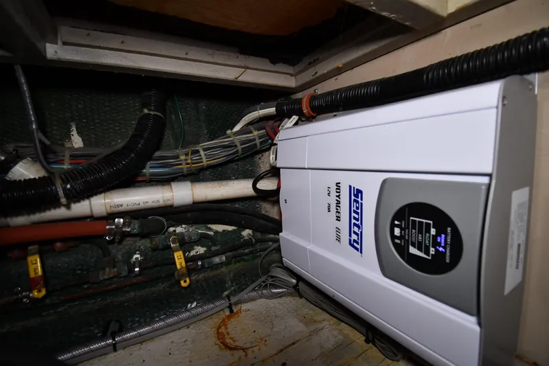Slide: The Image of Electrical system inside 1988 Viking 48 Convertible boat, featuring Sentry Voyager charger. - 63