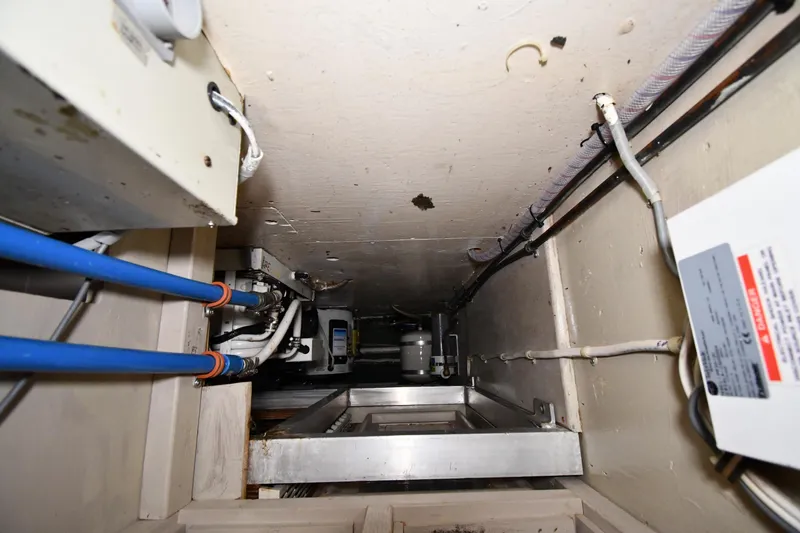 Slide: The Image of Engine room of 1988 Viking 48 Convertible boat with visible wiring and pipes. - 64