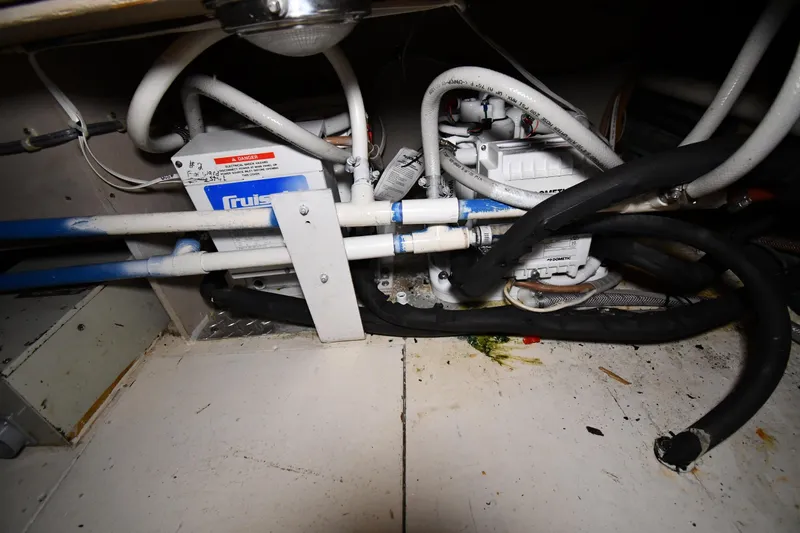 Slide: The Image of Engine room of 1988 Viking 48 Convertible with visible pipes and machinery. - 65