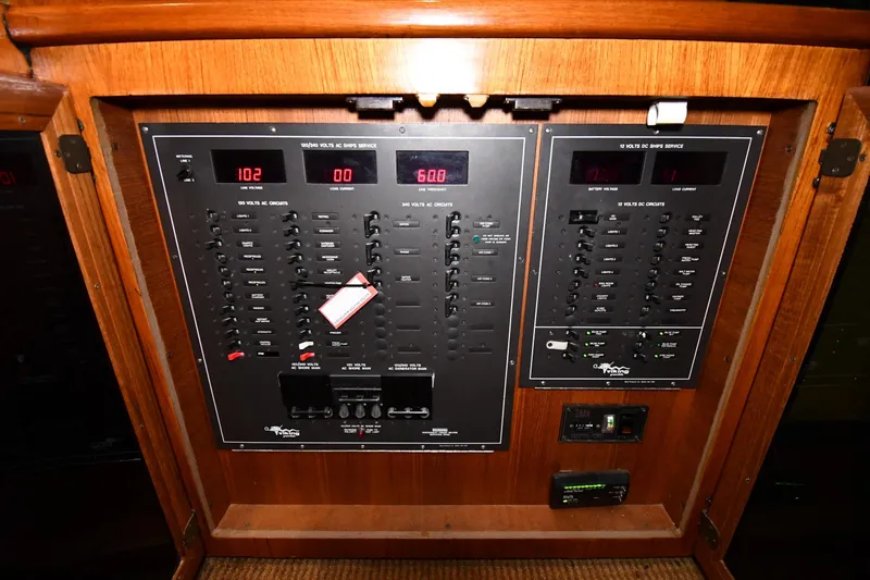 Slide: The Image of Electrical panel of a 1988 Viking 48 Convertible yacht, featuring various circuit controls. - 67
