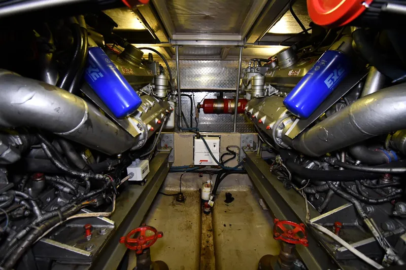 Slide: The Image of Engine room of 1988 Viking 48 Convertible yacht, showcasing dual engines and mechanical components. - 69