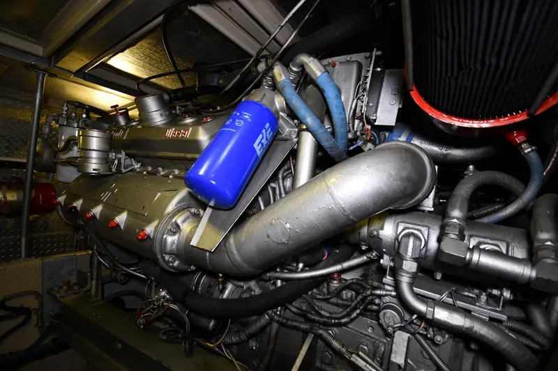 Slide: The Image of Engine room of a 1988 Viking 48 Convertible yacht, showcasing complex machinery and components. - 71