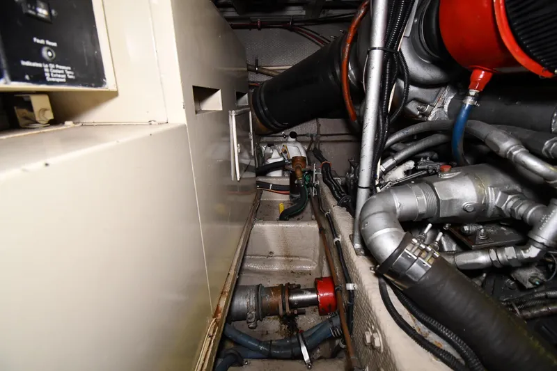 Slide: The Image of Engine room of 1988 Viking 48 Convertible with visible machinery and components. - 74