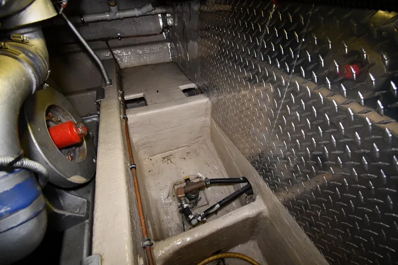 Slide: The Image of Engine room of 1988 Viking 48 Convertible yacht with metal paneling and machinery. - 78