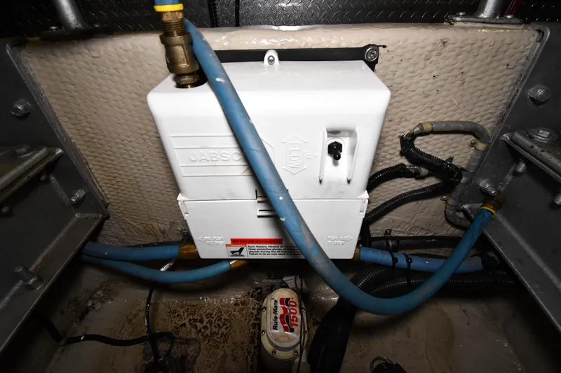 Slide: The Image of Engine room of 1988 Viking 48 Convertible with plumbing and electrical components. - 80