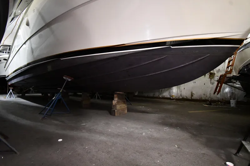 Slide: The Image of 1988 Viking 48 Convertible yacht on stands in a storage facility. - 86