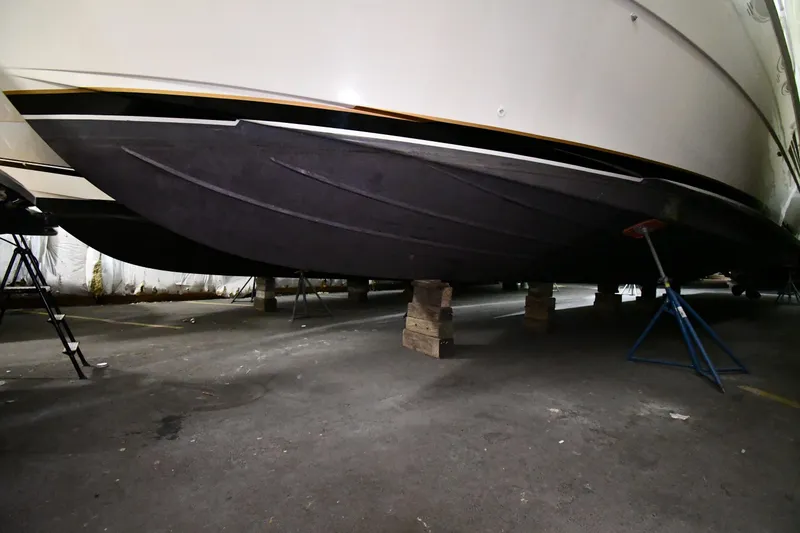 Slide: The Image of 1988 Viking 48 Convertible yacht hull on supports in storage facility. - 87