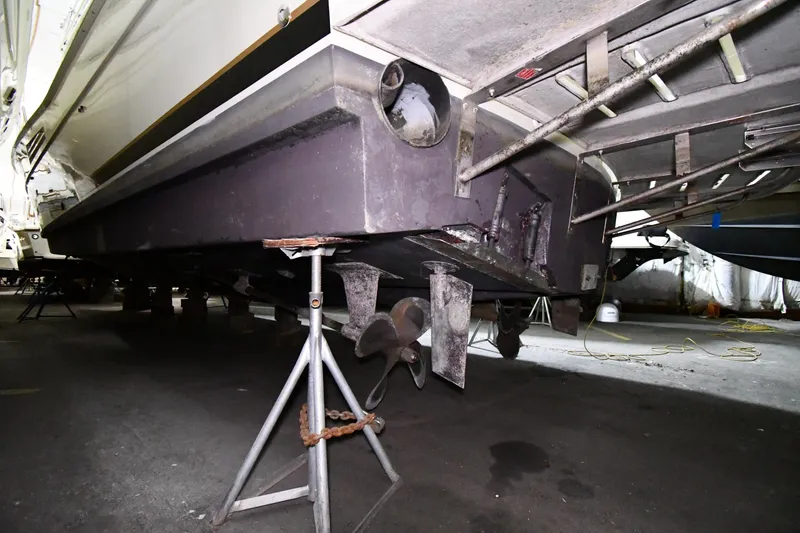 Slide: The Image of 1988 Viking 48 Convertible boat underside with propeller and support stands. - 88