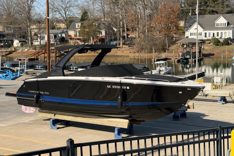 The Image of 2018 Chaparral 267 SSX boat on a dock, with a scenic waterfront background. - 0