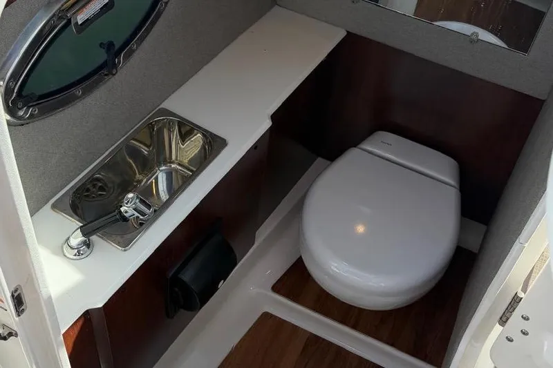 Slide: The Image of 2018 Chaparral 267 SSX boat bathroom with sink and toilet. - 13