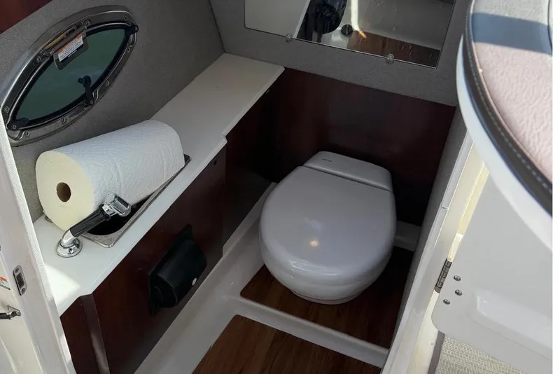 Slide: The Image of Interior of 2018 Chaparral 267 SSX with toilet and window. - 14