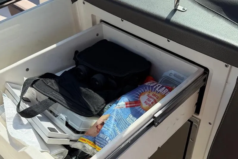 Slide: The Image of Storage compartment in Chaparral 267 SSX boat with accessories. - 17