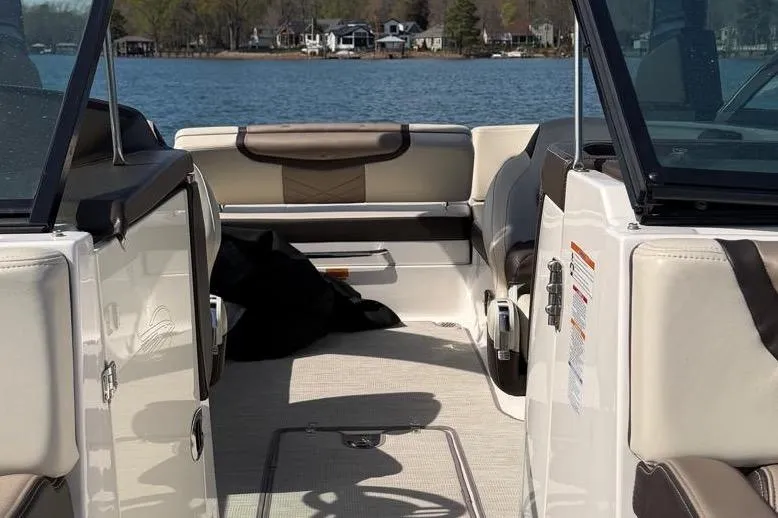 Slide: The Image of 2018 Chaparral 267 SSX boat interior with seating, on a lake. - 20