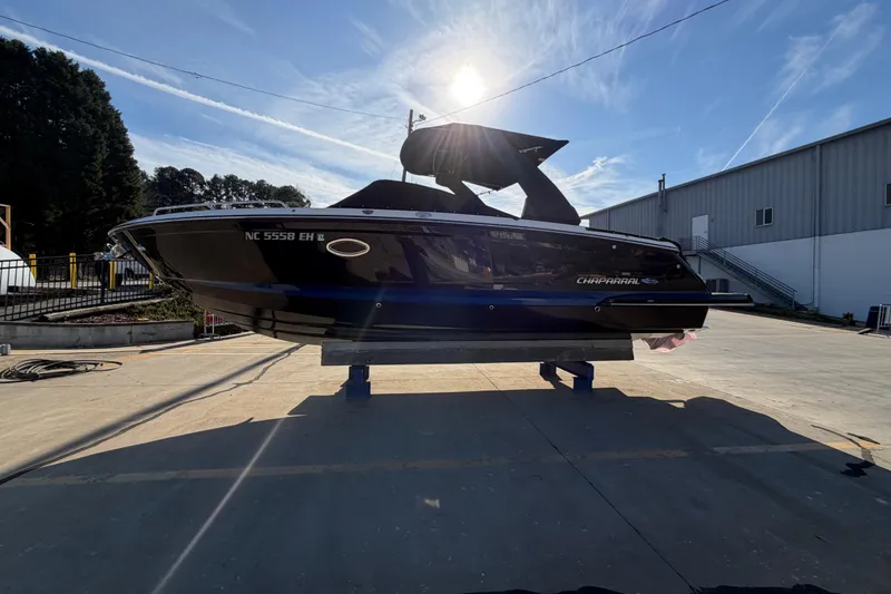 Slide: The Image of 2018 Chaparral 267 SSX boat on display outdoors, sunlit background. - 4