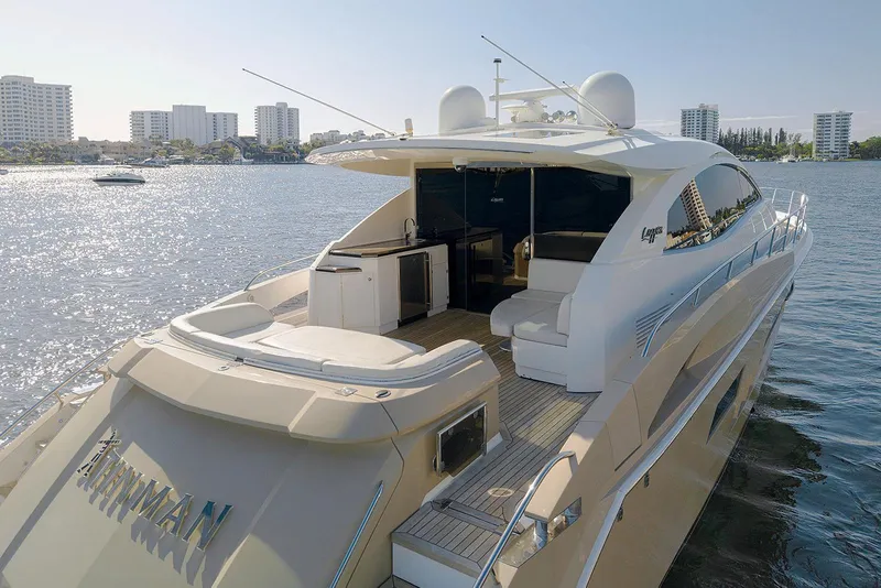 Slide: The Image of Luxurious 2013 Lazzara 64 yacht on serene water with city skyline backdrop. - 6