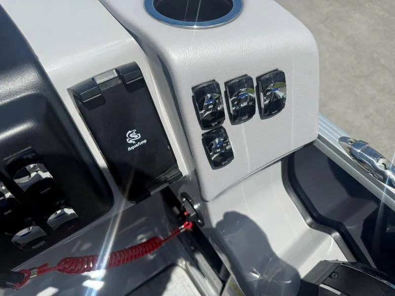 Slide: The Image of Dashboard of 2025 Harris Cruiser 210 FC with switches and cup holder. - 17