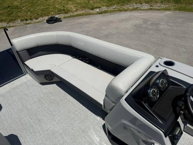 Slide: The Image of Interior of 2025 Harris Cruiser 210 FC with gray seating. - 18