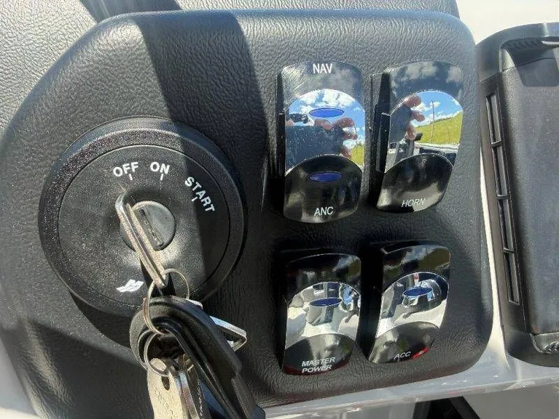 Slide: The Image of Control panel of 2025 Harris Cruiser 210 FC with ignition key and switches. - 32