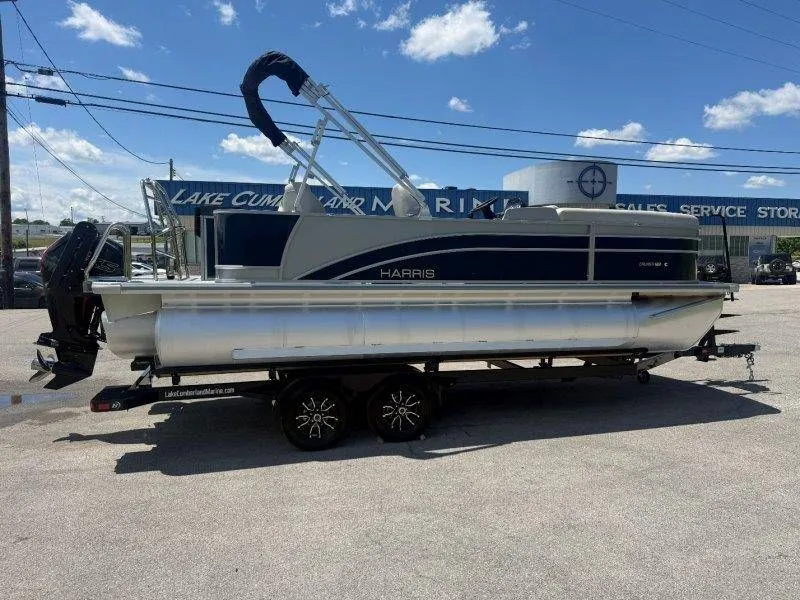 Slide: The Image of 2025 Harris Cruiser 210 FC pontoon boat on trailer outdoors. - 45