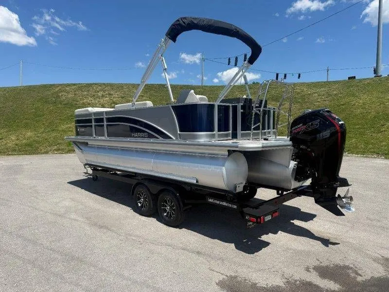 Slide: The Image of 2025 Harris Cruiser 210 FC pontoon boat on trailer outdoors. - 47