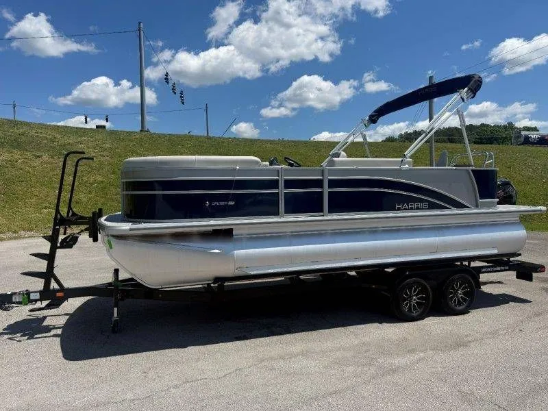 Slide: The Image of 2025 Harris Cruiser 210 FC pontoon boat on trailer under blue sky. - 49