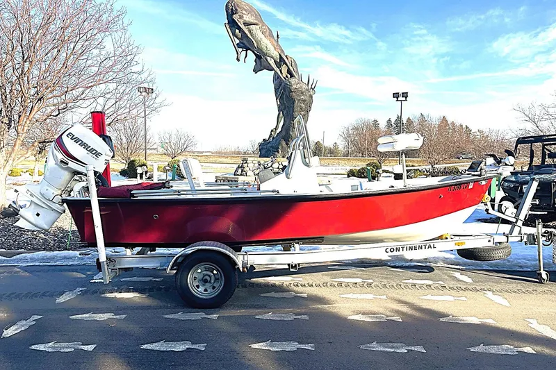 Slide: The Image of 2018 Boggy Creek Stryker 16 boat on trailer, red hull, Evinrude motor, outdoor setting. - 11