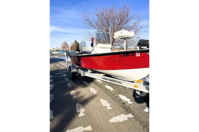 Slide: The Image of 2018 Boggy Creek Stryker 16 boat on trailer, parked on fish-patterned pavement. - 13