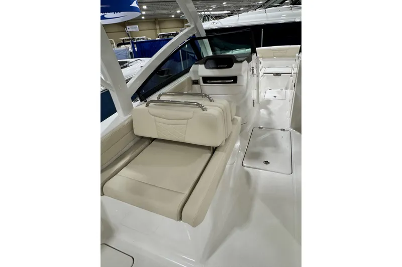 Slide: The Image of 2026 Robalo R257 Dual Console boat interior with beige seating and sleek design. - 15