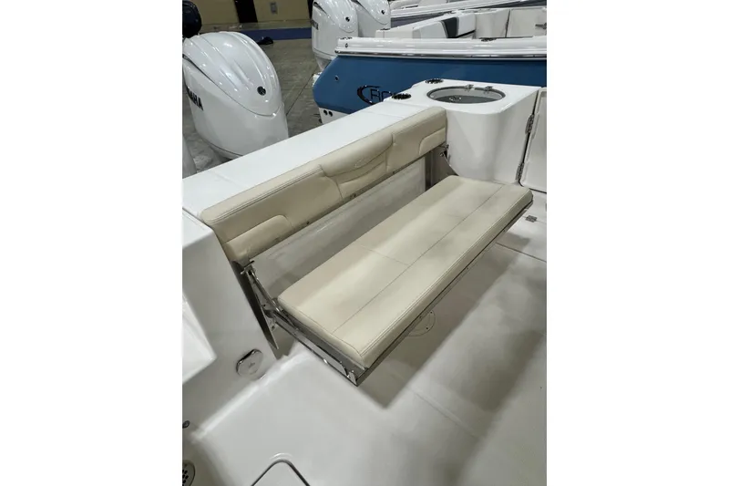 Slide: The Image of 2026 Robalo R257 Dual Console boat with beige foldable seating and modern design. - 8
