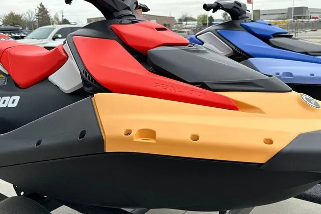Slide: The Image of 2026 Sea-Doo PWC SPARK in red and yellow on parking lot. - 8
