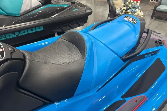 Slide: The Image of A Sea-Doo jet ski with a blue and black seat, modern design, and control console. - 27