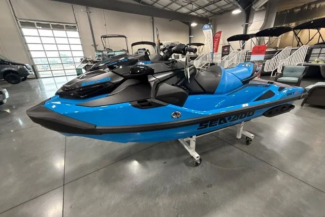 The Image of A blue Sea-Doo jet ski is displayed in a showroom. It features a sporty design with black accents. - 1