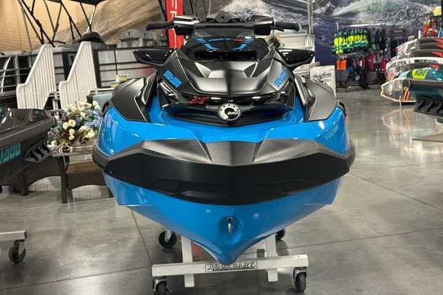 Slide: The Image of A blue Sea-Doo jet ski is displayed in a showroom on a rolling stand. - 3