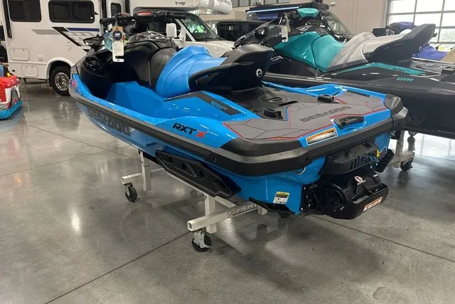 Slide: The Image of A blue 2026 Sea-Doo PWC RXT X 325 displayed in a showroom. - 5