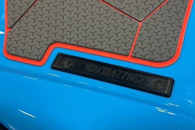 Slide: The Image of Close-up of a blue Sea-Doo with non-slip mats and a serial number. - 34