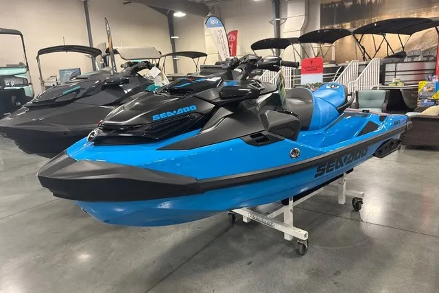 Slide: The Image of A blue 2026 Sea-Doo PWC RXT X 325 displayed in a showroom. - 2