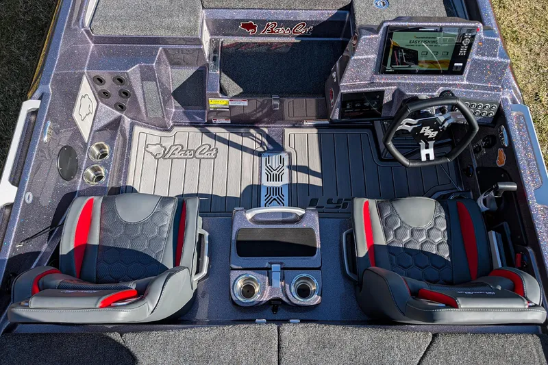 Slide: The Image of 2026 Bass Cat Lynx STS boat interior with dual seats, steering wheel, and control panel. - 11