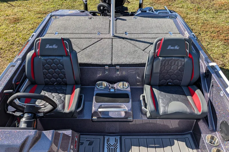 Slide: The Image of 2026 Bass Cat Lynx STS boat interior with dual seats and steering wheel. - 15