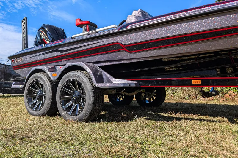 Slide: The Image of 2026 Bass Cat Lynx STS boat on trailer, showcasing sleek design and modern wheels. - 4