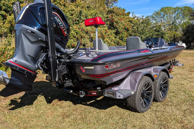 Slide: The Image of 2026 Bass Cat Lynx STS boat on trailer, featuring sleek design and powerful engine. - 7