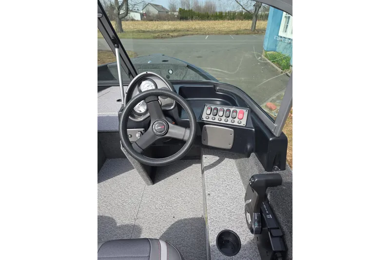 Slide: The Image of 2026 Alumacraft Classic 165 Sport boat dashboard with steering wheel and control panel. - 6