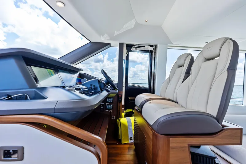 Slide: The Image of 2024 Princess Y72 Motor Yacht helm with luxurious seating and modern controls. - 18