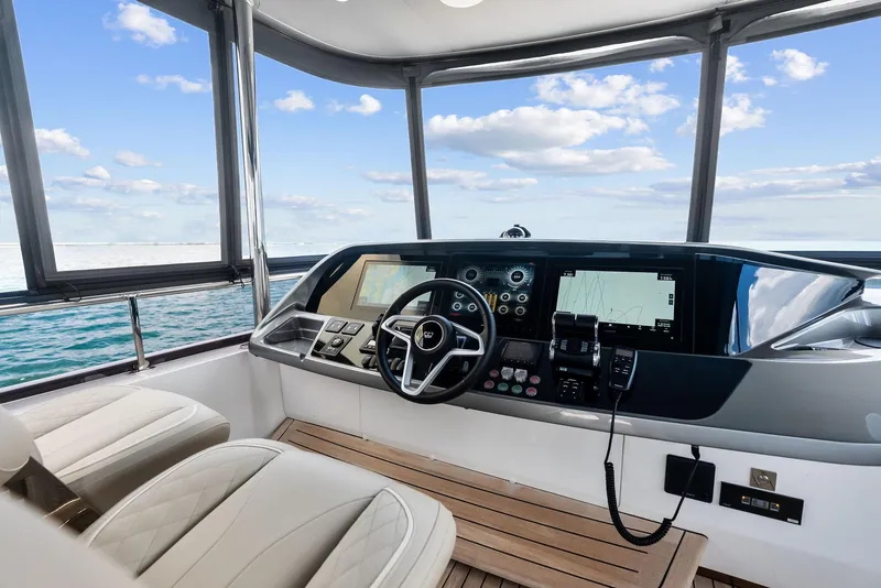 Slide: The Image of 2024 Princess Y72 Motor Yacht helm with modern controls and ocean view. - 20
